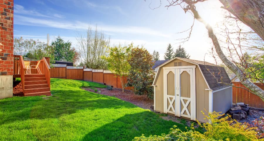 Fenced backyard with storage shed in Lawrence